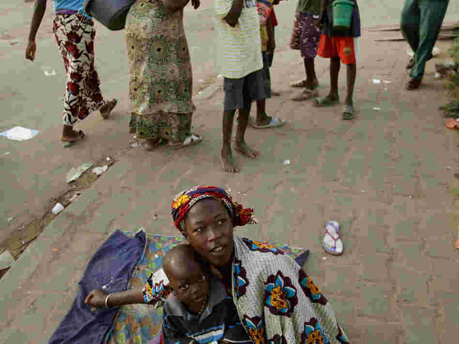 A Senegalese woman and her son beg in Dakar