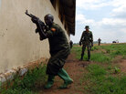 A European soldier oversees training of a Somali soldier at a training camp in Uganda A European soldier oversees training of a Somali soldier at a training camp in Uganda
