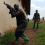 A European soldier oversees training of a Somali soldier at a training camp in Uganda