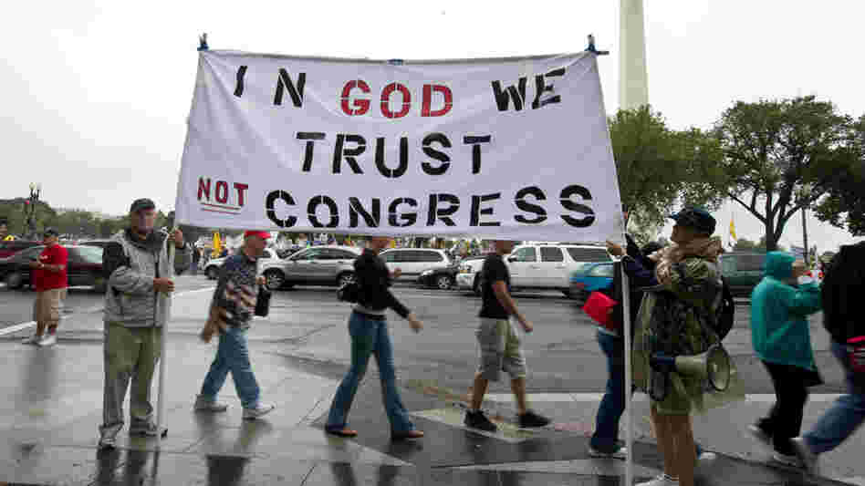 Tea Party supporters hold a sign in front of the Washington Monument during a march on Sept. 12.