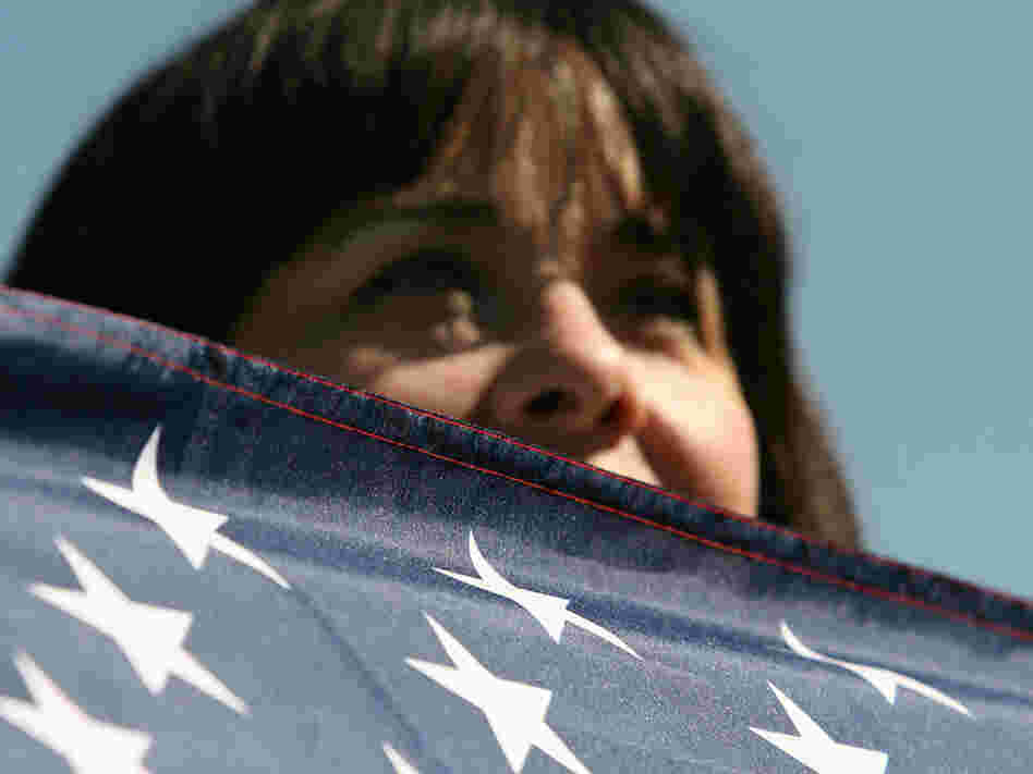 A person with an American flag participates in the One Nation March 