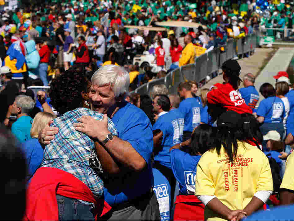 Erica DeVose, left, is hugged by Mike Crossey
