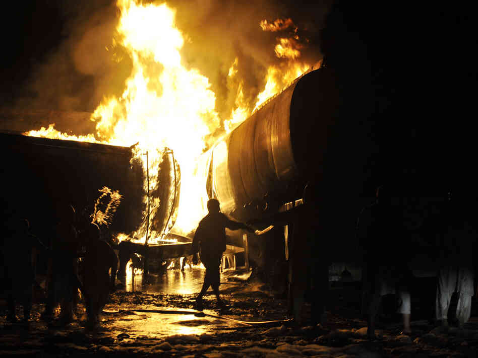 Firefighters battle oil tanker fire