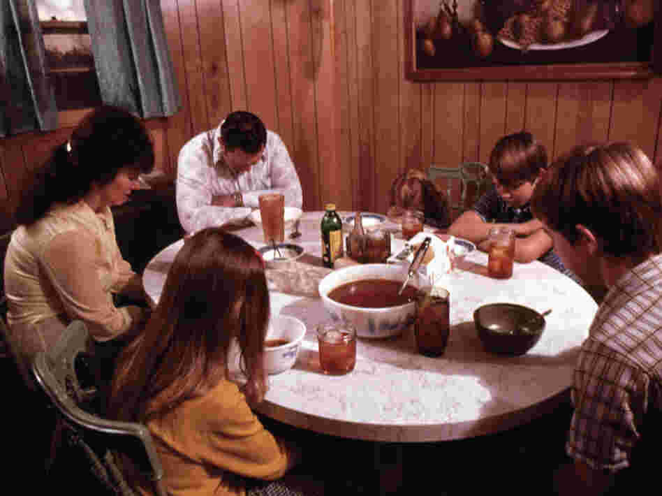 The Gipson family says a prayer before their evening meal in Chattanooga, Tenn.