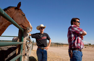 Terry Walter (right) and his son Ty stand next to one of the horses they use to round up cattle. Next year, Ty plans to go to college to major in agricultural business in hopes of running the family business.
