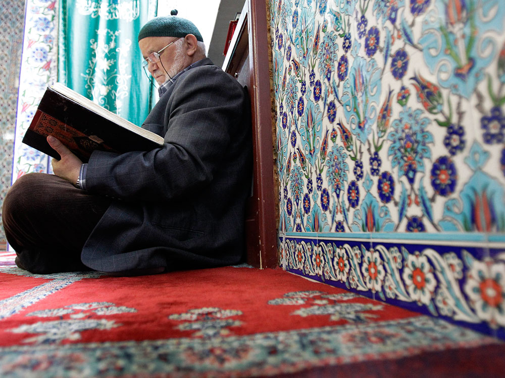 A man reads the Quran at a mosque in Hamburg, Germany, Oct. 7.