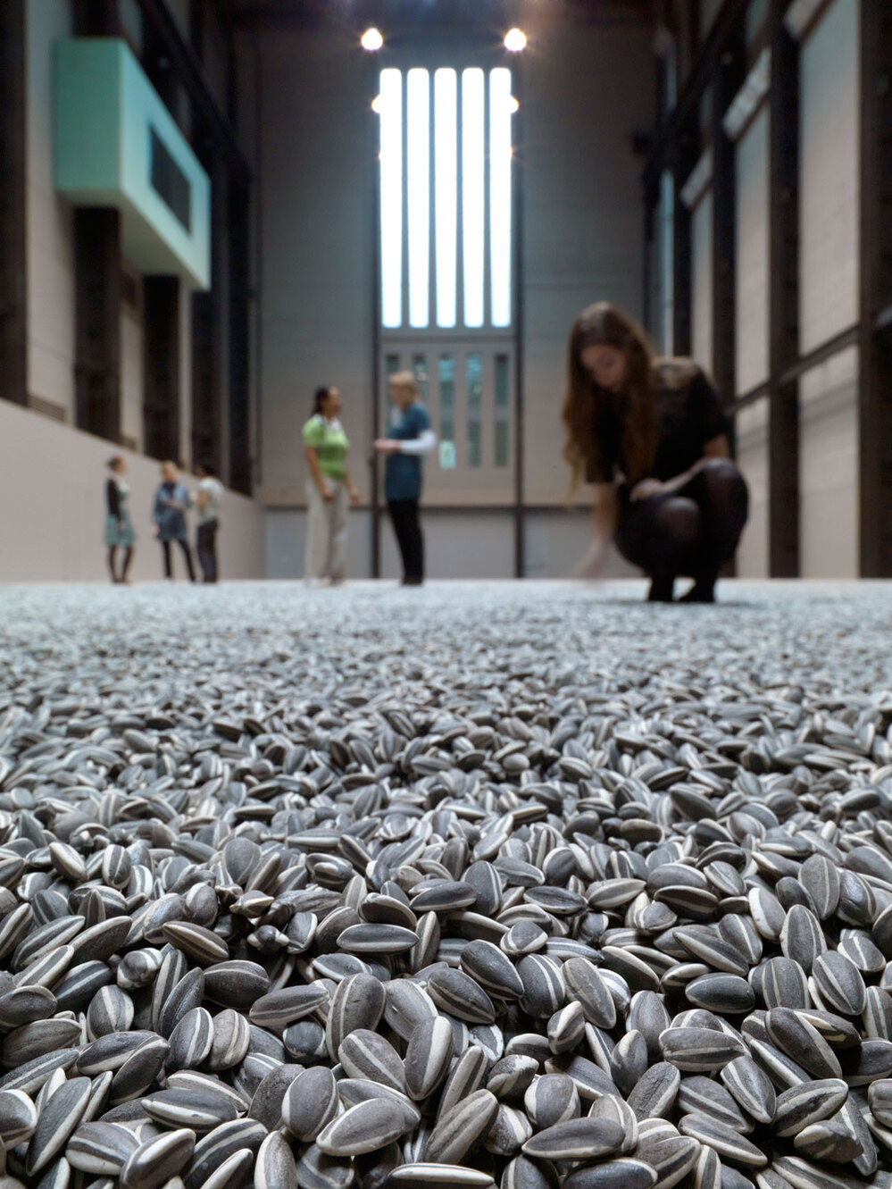 Visitors to the Tate Museum interact with Weiwei's intallation