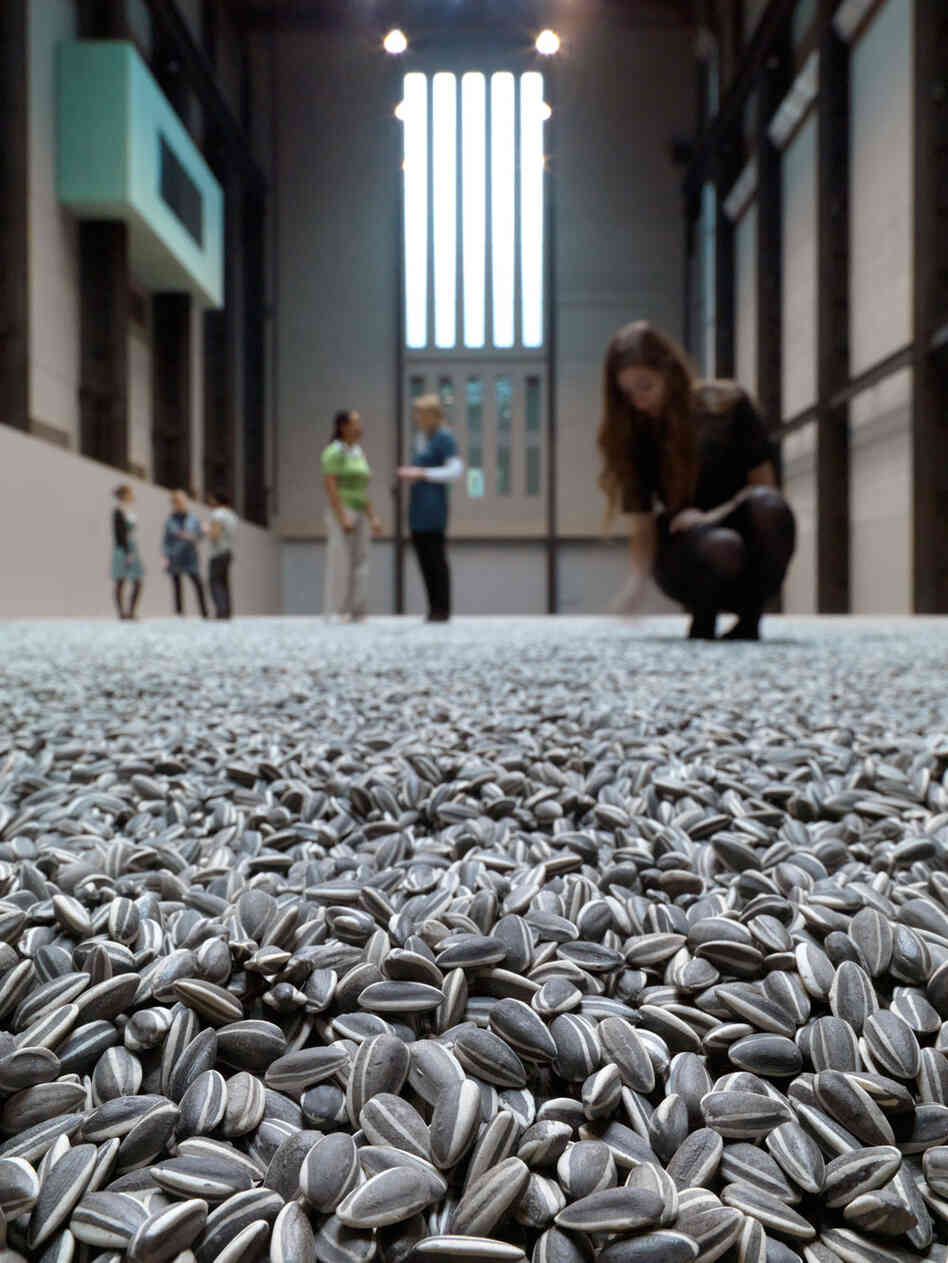 Visitors to the Tate Museum interact with Weiwei's intallation