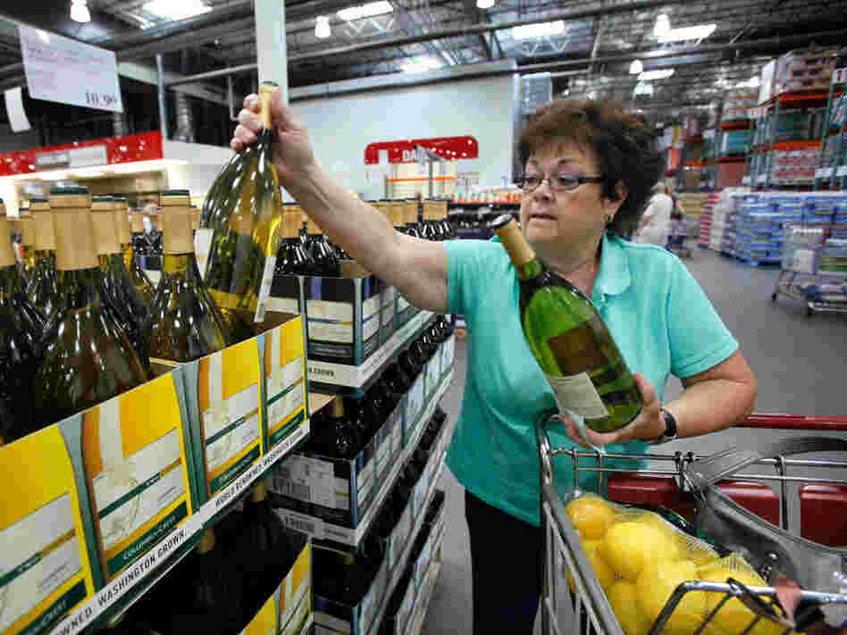 Georgia LaBelle reaches for a bottle of wine as she shops at a Costco warehouse store in Seattle.
