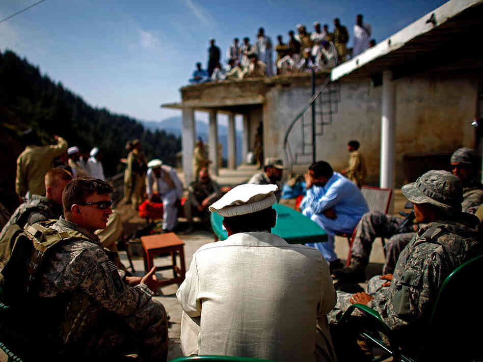 Army Capt. Thomas Billig shares a cup of tea and lunch with Pakistani Army Lt. Col. Ahmed Salim at the border