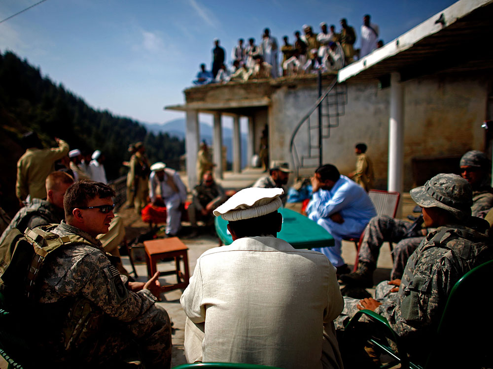 Army Capt. Thomas Billig shares a cup of tea and lunch with Pakistani Army Lt. Col. Ahmed Salim at the border