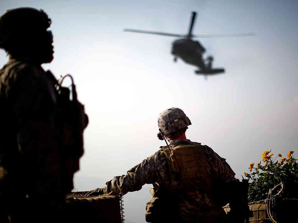 1st Sgt. Kenneth Bolin watches a resupply helicopter circle overhead