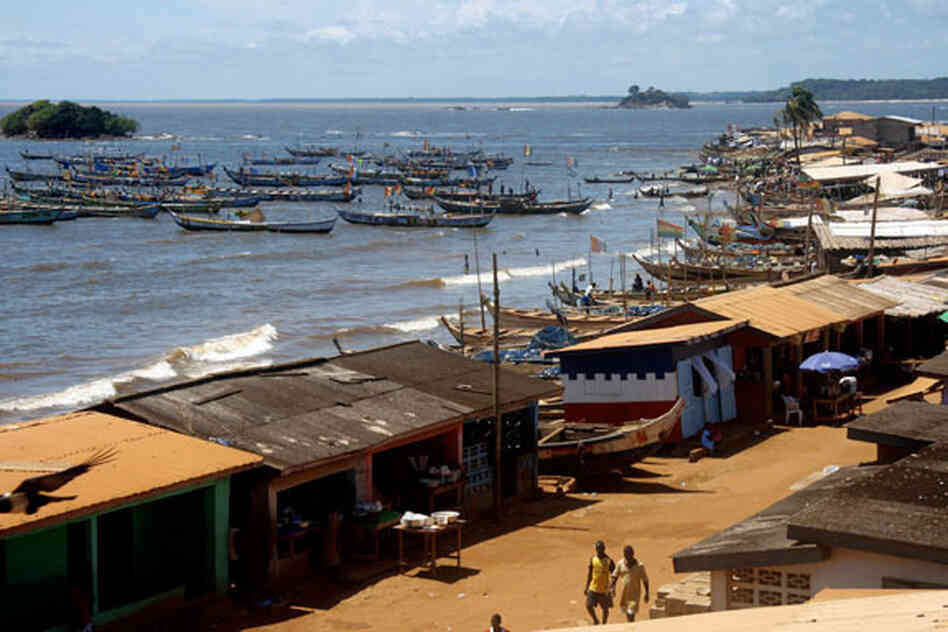 Dugout wooden fishing canoes bobbing on the Atlantic Ocean, beneath the village of Apewosika in central Ghana. Dugout wooden fishing canoes bobbing on the Atlantic Ocean, beneath the village of Apewosika in central Ghana.