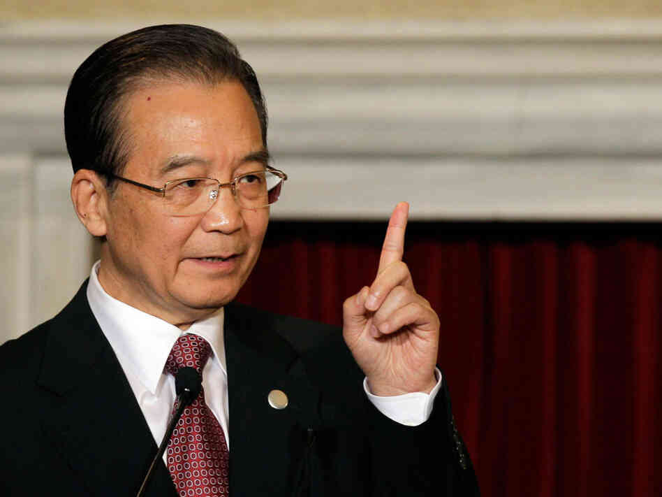 Chinese Premier Wen Jiabao gestures during a joint press conference with Italian Premier Silvio Berlusconi, at