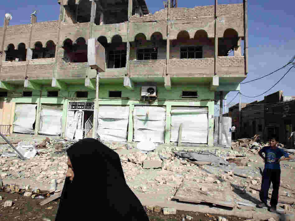 Iraqis inspect the site of an alleged overnight U.S. airstrike in Baghdad's Sadr City in March 2008