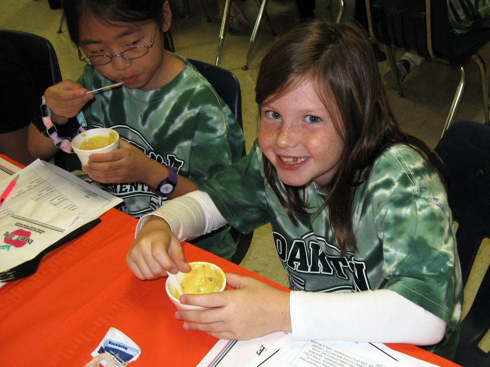 Third graders (from right) Kalli Cannistraro and Emily Park sample healthy food options at Oakton Elementary.