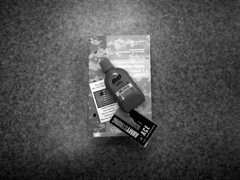 A bottle of hand sanitizer, suicide prevention help card