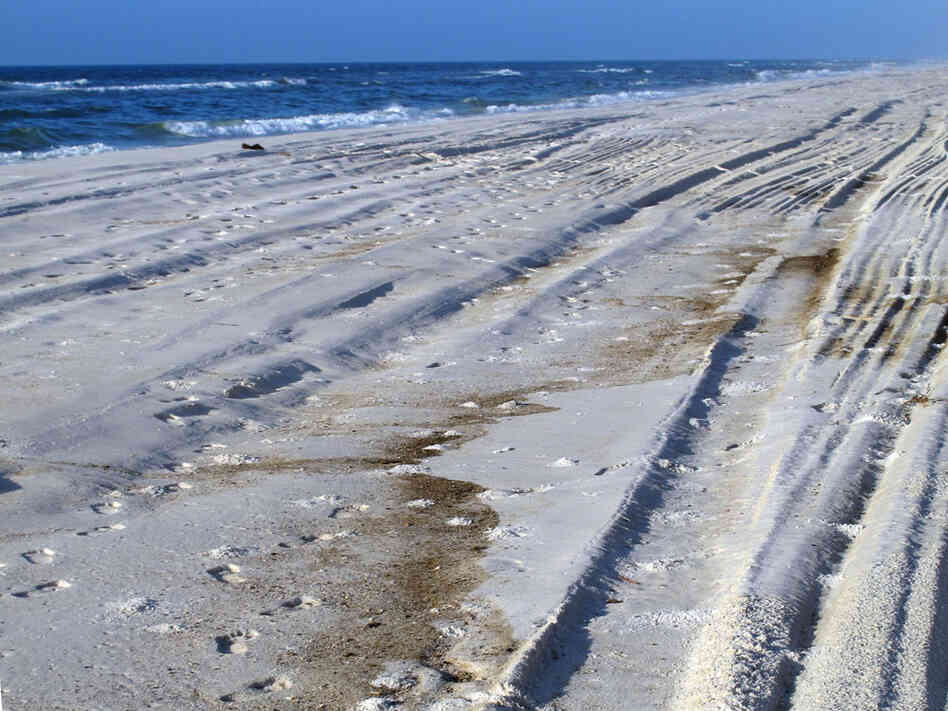 Waves breaking on the shore in Orange Beach, Ala., leave behind an oily residue. Waves breaking on the shore in Orange Beach, Ala., leave behind an oily residue.