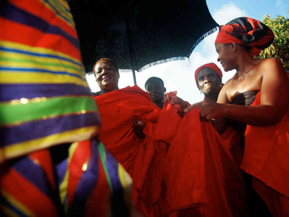 During the traditional funeral ceremonies for her late uncle, "King Peggy" is required to get up and dance. 