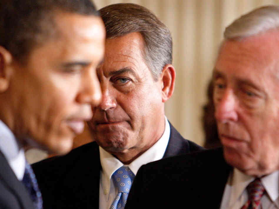 John Boehner looks on as President Obama talks to Steny Hoyer.