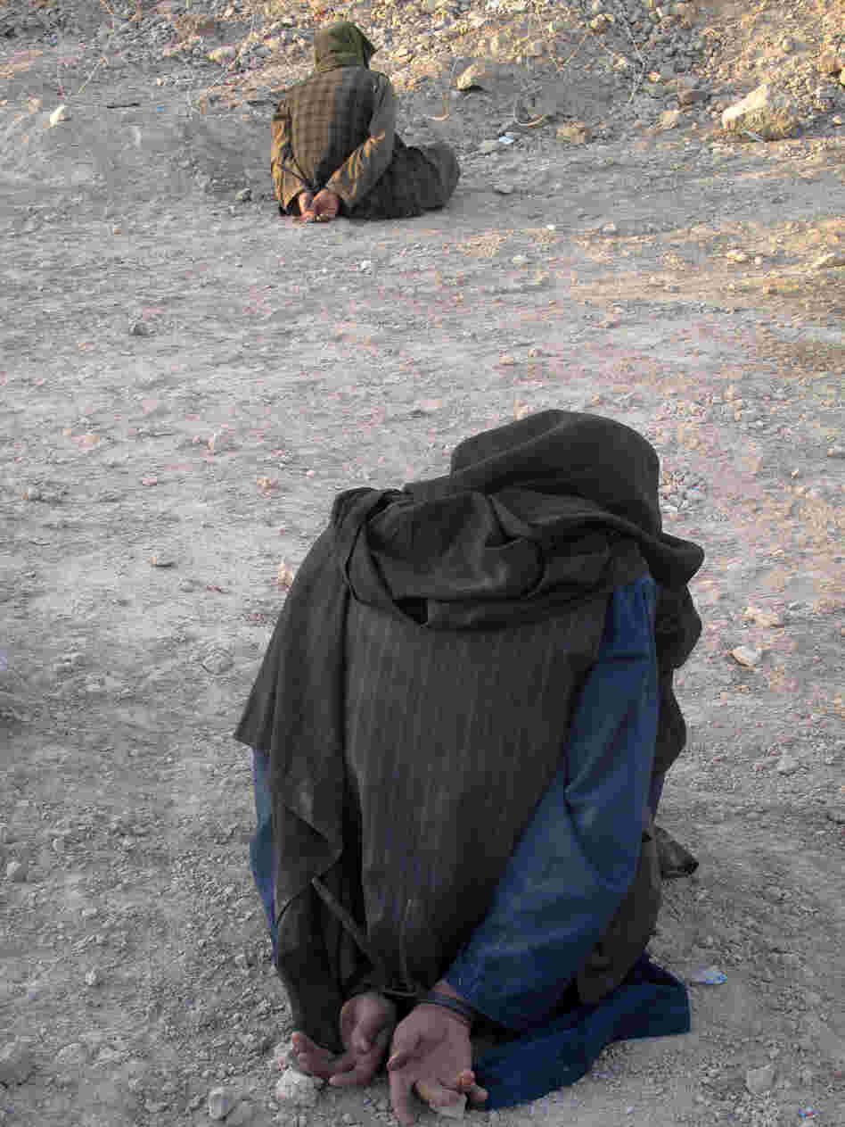 Afghan men are detained for questioning by U.S. soldiers. Afghan men are detained for questioning by U.S. soldiers.