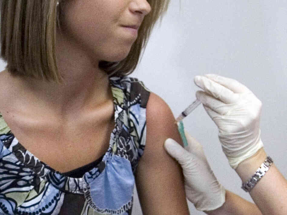 An 18 year old winces as she has her third and final application of the HPV vaccine.