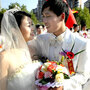 Chinese newlyweds pose during a collective wedding ceremony in Shanghai