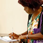A homeowner fills out a form to request mortgage information. A homeowner fills out a form to request mortgage information.