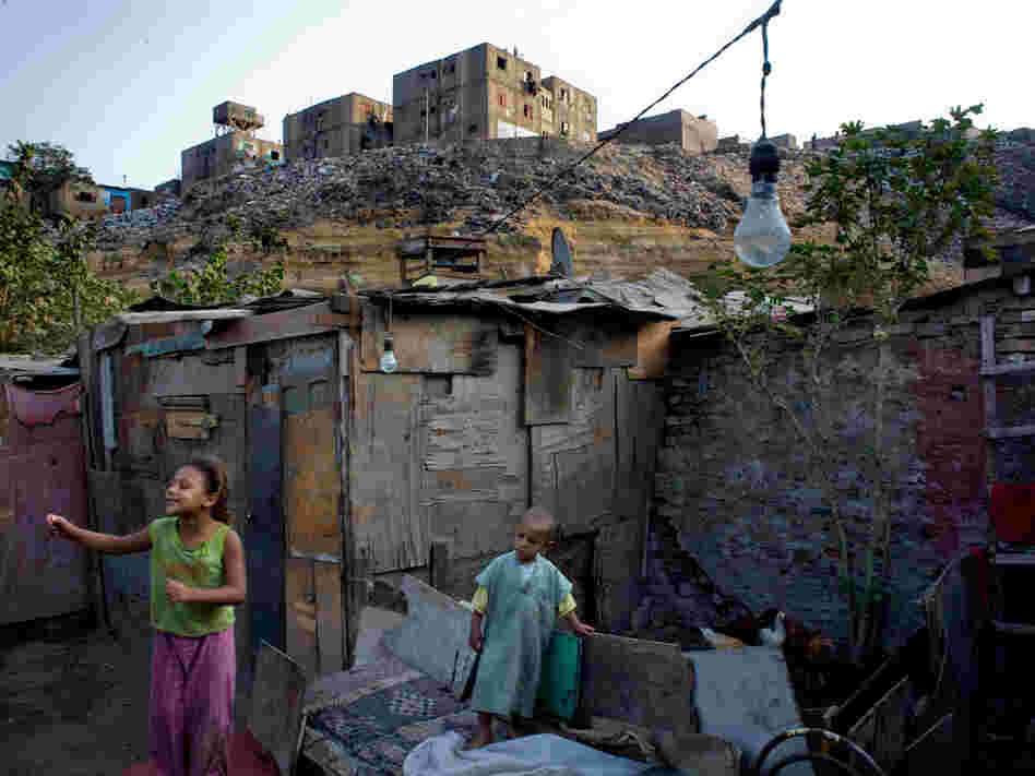 Children play near their home in the Duweika area of Cairo