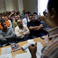 Volunteers packed into a room during a petition-drive training session in Cairo. 