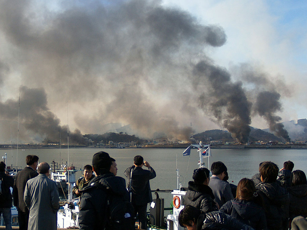 A picture taken by a South Korean tourist shows plumes of smoke rising from Yeonpyeong island.