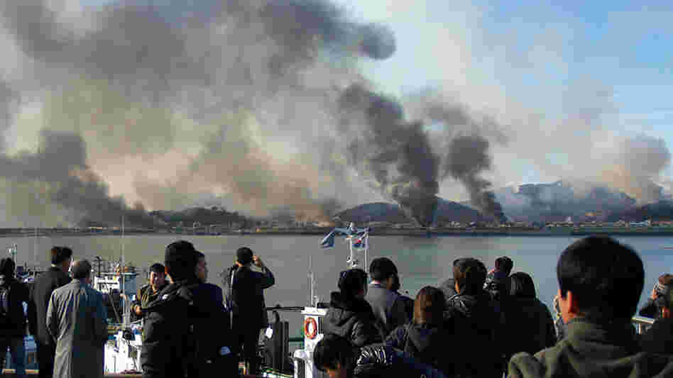 A picture taken by a South Korean tourist shows plumes of smoke rising from Yeonpyeong island.