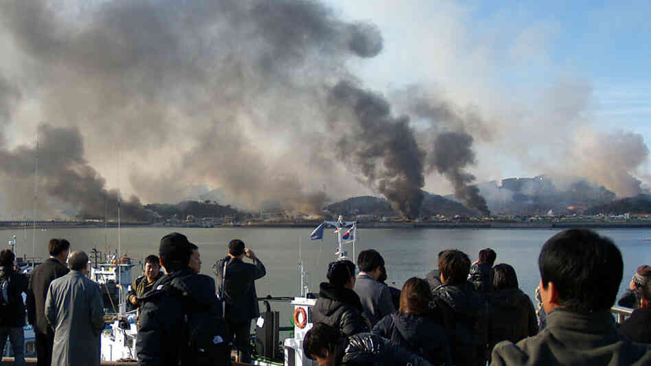 A picture taken by a South Korean tourist shows plumes of smoke rising from Yeonpyeong island.