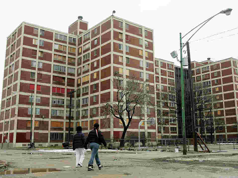 Two residents walk past Chicago's Cabrini-Green public housing buildings.