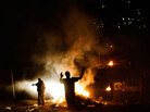 Fires burn along the streets of Petionville, Haiti, on Tuesday. Fires burn along the streets of Petionville, Haiti, on Tuesday.