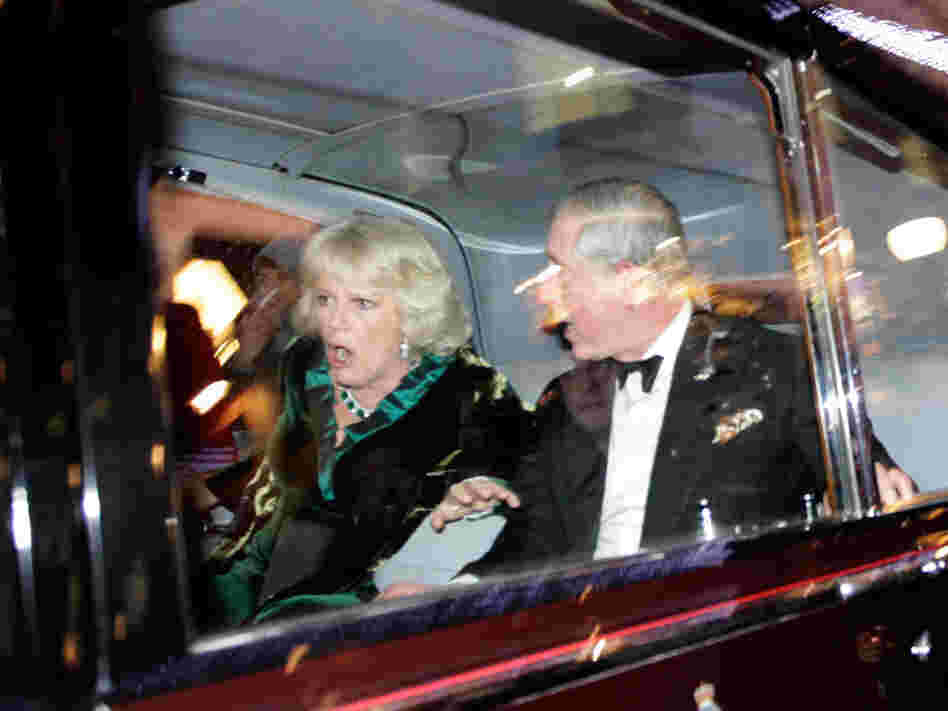 Charles and Camilla react during the attack.