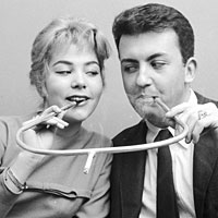 A cigarette holder built for two, circa 1955