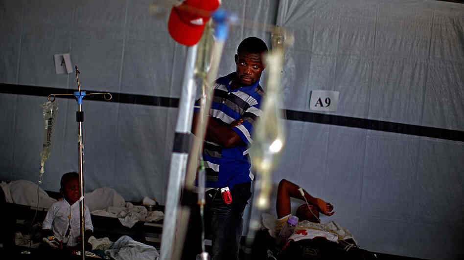 A man looks over a room of cholera victims in Port au Prince, Haiti 