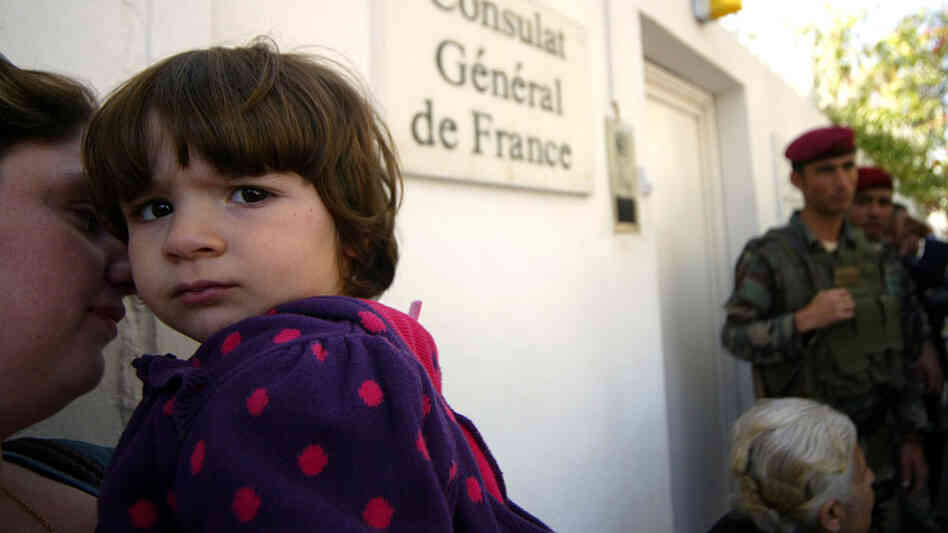 Iraqi Christians hoping to emigrate to France wait outside French Consulate in Irbil