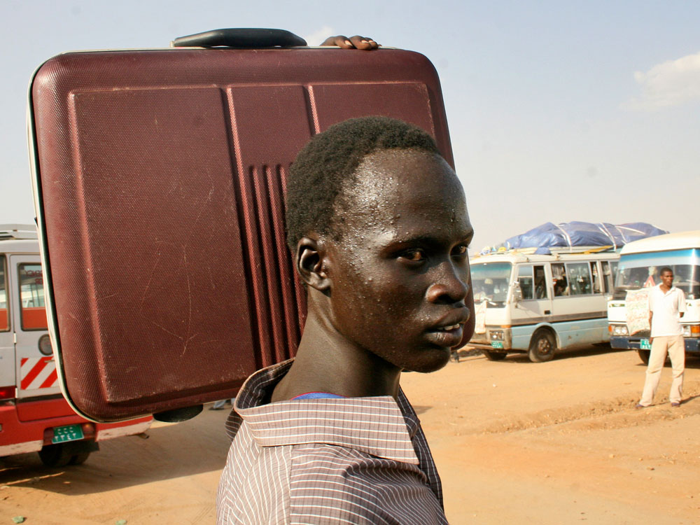 Southern Sudanese man waits to board a bus that will take him from Khartoum to Southern Sudan Southern Sudanese man waits to board a bus that will take him from Khartoum to Southern Sudan