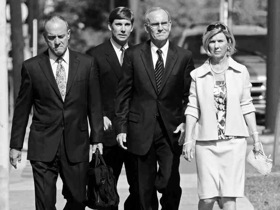 Dickie Scruggs walks with his family and attorney into court