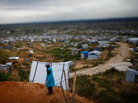 A woman walks through a tent city outside the Haitian capital, Port-au-Prince A woman walks through a tent city outside the Haitian capital, Port-au-Prince