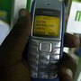 A man sends money through M-Pesa
