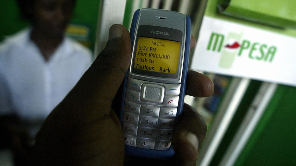 A man sends money through the mobile phone service M-PESA in  Kenya's capital, Nairobi, in 2007. M-PESA is having a clear economic impact, including boosting consumer spending in the countryside.