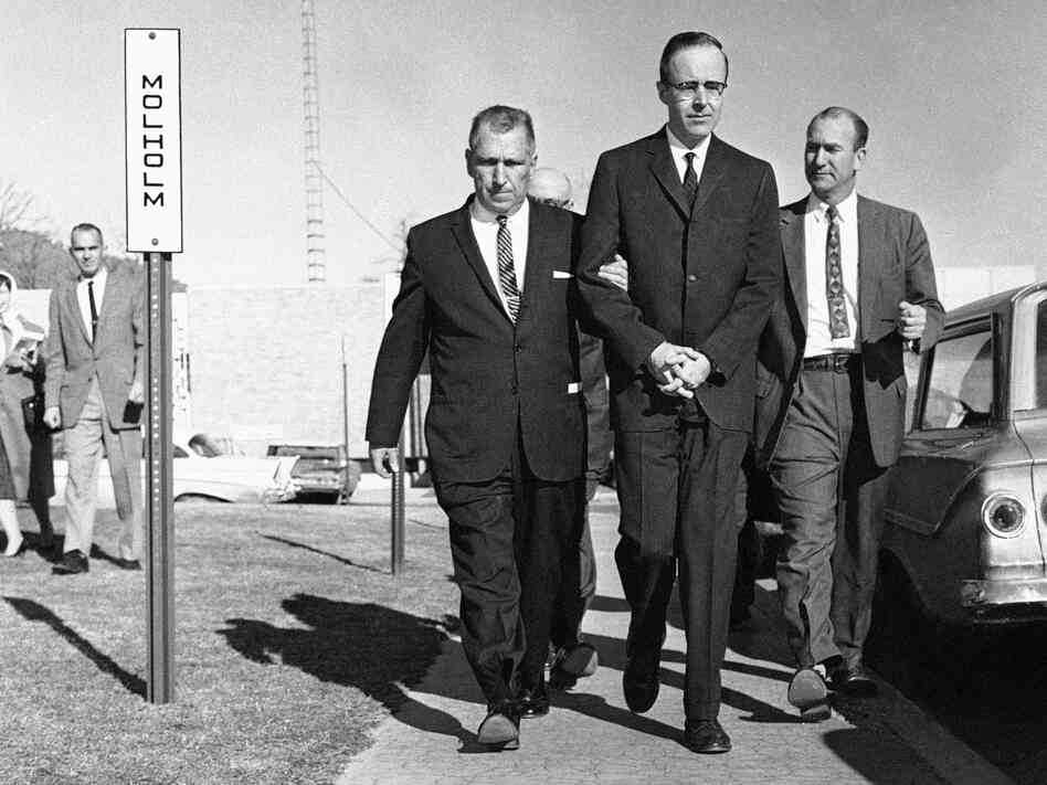 Joseph Corbett (center), who was convicted of killing millionaire Adolph Coors III, is led to the Jefferson County courthouse in Golden, Colo., in 1961.