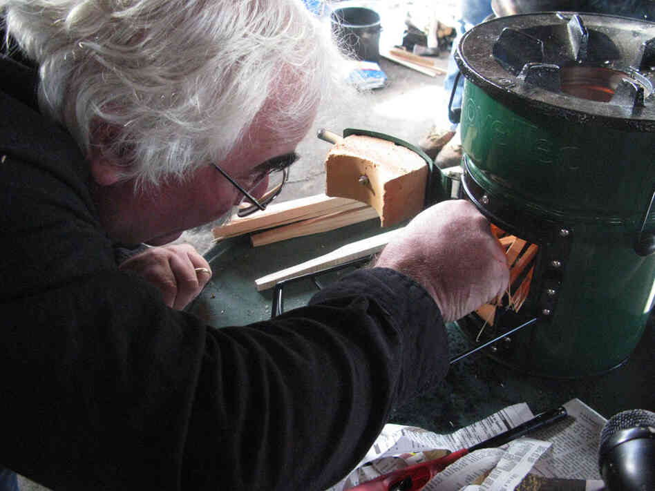 Aprovecho executive director Dean Still lights a "rocket stove." Once the fire is going, it takes only two or three sticks at a time to keep a pot of water boiling.