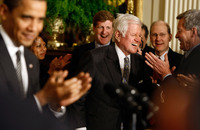 <strong>March 2009:</strong> Kennedy receives a standing ovation from President Obama and others as he arrives at the White House's forum on health care reform.
