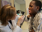 A Massachusetts doctor examines a patient. A Massachusetts doctor examines a patient.