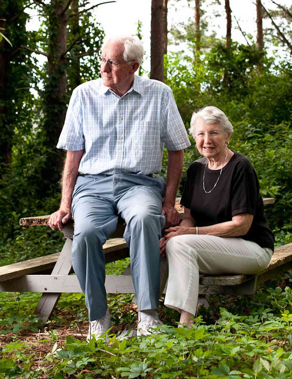 Earle and Virgina Helton sit outside their home.