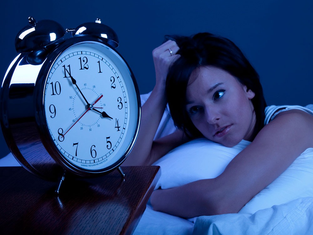 Woman looks at clock at 4 a.m.
